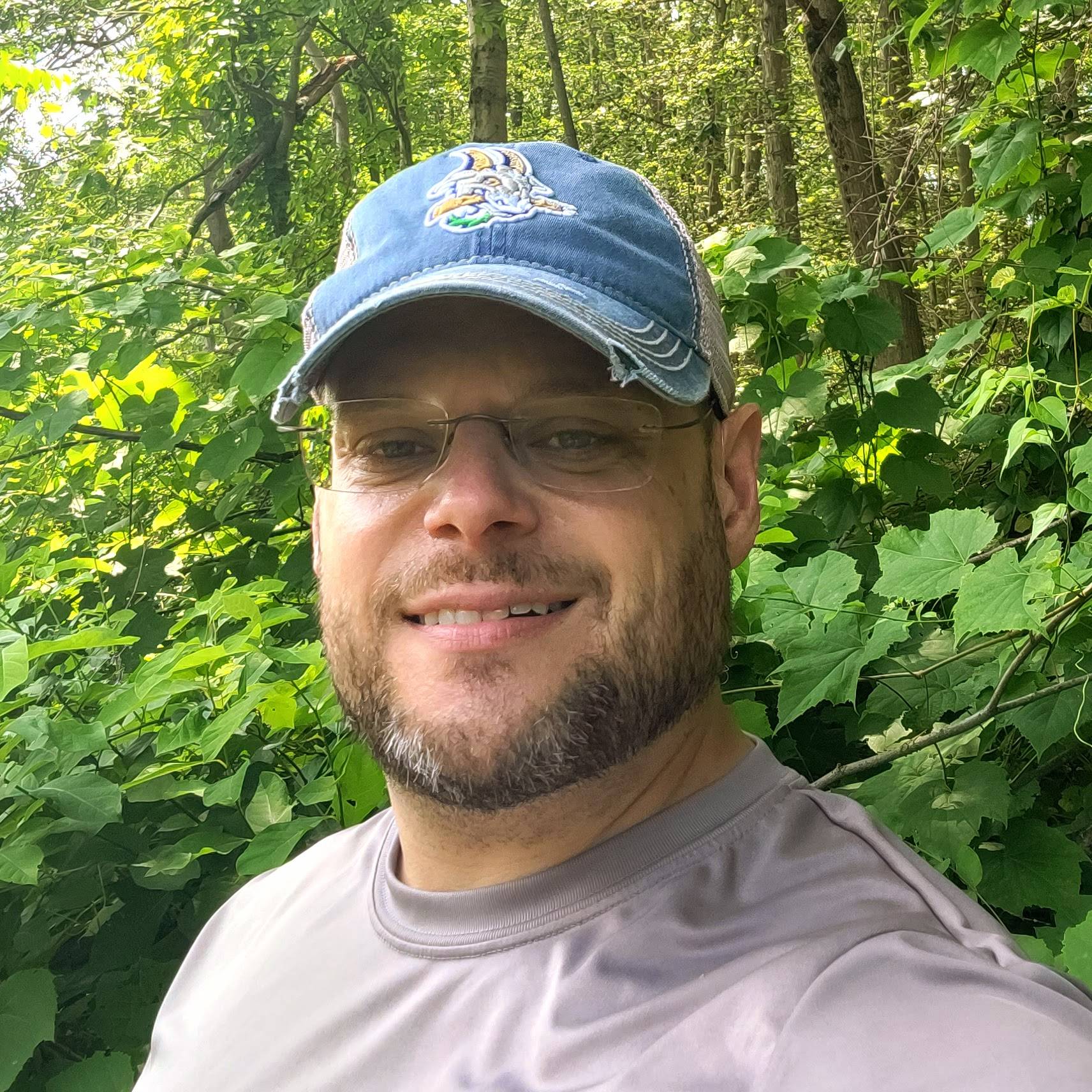 John Syc, founder of Authentic Perspectives, smiling in a professional headshot.